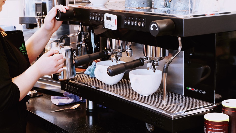 someone using coffee maker