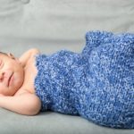 baby in blue blanket