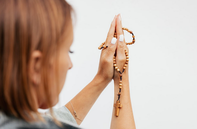 woman holding a rosary